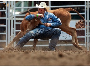Louisiana cowboy Tyler Pearson competes in the steer wrestling event at the Calgary Stampede rodeo on Wednesday, July 14, 2021. 

Gavin Young/Postmedia