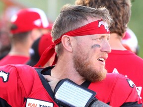Calgary Stampeders quarterback Bo Levi Mitchell is seen on the sidelines favouring his shoulder during  a game against the B.C. Lions in this photo from June 29, 2019.