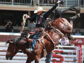 Lefty Holman from Visalia, Calif., rides Don't See You to an 85.00 in the saddle bronc event at the Calgary Stampede rodeo on Tuesday. 

Gavin Young/Postmedia