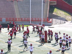 Calgary Stampeders players exercise and stretch near the uprights during a recent practice.