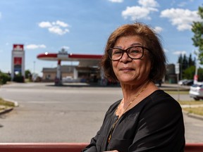 Zubeda Jessa poses for a photo outside Horseman liquor store, run by her family, neighbouring a Petro-Canada gas station in Airdrie on Thursday, August 12, 2021.