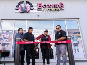 Tyler White, Siksika Health Services CEO, left, Manny Yellowfly, Therapeutic Physical Trainer, Dr. Quintina Bearchief-Adolpho, Siksika Health Mental Health Clinical Lead, and Richard Running Rabbit, Siksika Parks and Recreation, cut the ribbon at the grand opening of The Many Guns Boxing & Fitness Center on Siksika Nation on Saturday, August 21, 2021.