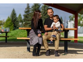 Jihan, left, and Sharif Sharifi and their two-year-old son Armaan pose for a photo at South Calgary Park on Friday, August 27, 2021.