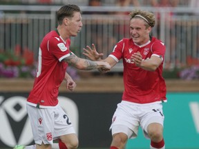 Cavalry FC’s Joe Mason (left) celebrates his goal against FC Edmonton with teammate Dan Kaiser during Canadian Premier League action at ATCO Field in Calgary on Tuesday, Aug. 3, 2021.