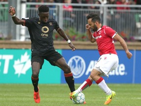 Cavalry FC’s Sergio Camargo (right) makes a turn in front of Valour FC’s Arnold Bouka Moutou at ATCO Field on Sunday, Aug. 8, 2021.