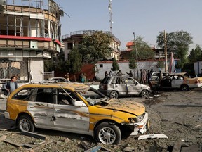 Damaged cars are seen at the site of a night-time car bomb blast in Kabul, Afghanistan, Wednesday, Aug. 4, 2021.