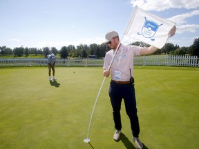 Shaw Charity Classic operations assistant Hudson Kinvig checks over the set-up in preparations for the tournament at Canyon Meadows Golf and Country Club in Calgary on Monday, Aug. 9, 2021.