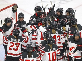 Canadian players celebrate after a 5-1 win over the U.S. at the IIHF Women’s World Championship at the Winsport arena in Calgary on Aug. 26, 2021.