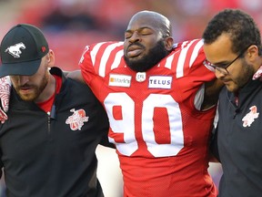 Calgary Stampeders Folarin Orimolade is helped off the field during a game against Montreal Alouettes in CFL football in Calgary on Friday, August 20, 2021. AL CHAREST / POSTMEDIA