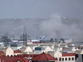 Smoke rises from explosions outside the airport in Kabul, Afghanistan, on Aug. 26, 2021.