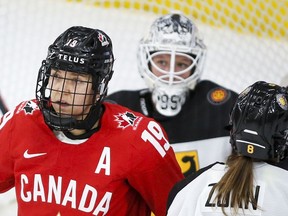Canada's Brianne Jenner, left, celebrates her goal as German goalie Franziska Albl looks on during first-period quarterfinal action at the IIHF Women's World Championship hockey in Calgary on Saturday.