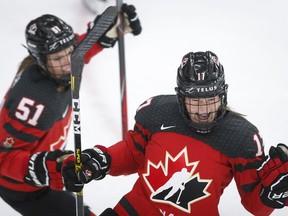 Canada’s Ella Shelton, right, celebrates her goal against the Russian Olympic Committee club with teammate Victoria Bach during the IIHF women’s world championship at WinSport Arena in Calgary, on Sunday, Aug. 22, 2021.