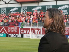 Cavalry FC Tommy Wheeldon Jr watches just before the match as the Foot Soldiers supporters line the stands during CPL soccer action in Calgary between Cavalry FC and Edmonton FC at Atco Field onTuesday, August 3, 2021. Jim Wells/Postmedia