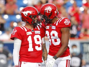 The Calgary Stampeders quarterback Bo Levi Mitchell and Kamar Jorden celebrate a TD against the Toronto Argonauts in first half CFL action at McMahon stadium in Calgary Saturday, August 7, 2021. Darren Makowichuk/Postmedia