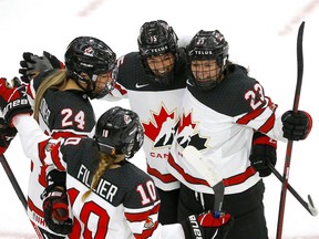Canadian players celebrate a goal by Melodie Daoust against Switzerland during the IIHF women’s world championship at WinSport Arena in Calgary on Tuesday, Aug. 24, 2021.