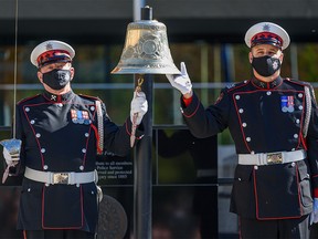 Members of the Calgary Fire Department Honour Guard ring a ceremonial fire bell to honour the memory of fallen firefighters and those who lost their lives to work-related illnesses at a memorial ceremony at Police Officers and Firefighters Tribute Plaza outside Calgary Municipal Building on Tuesday, September 14, 2021.