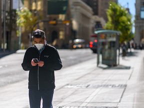A pedestrian wears a mask to prevent the spread of COVID-19 while walking in downtown Calgary on Tuesday, September 21, 2021.