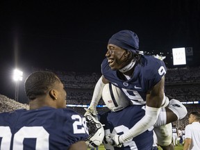 Joey Porter Jr., of the Penn State Nittany Lions, celebrates with teammates after the game against the Auburn Tigers at Beaver Stadium this past Saturday in State College, Pa.