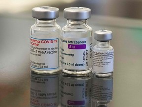 Three vials with different vaccines against COVID-19 by (L-R) Moderna, AstraZeneca and Pfizer-BioNTech.