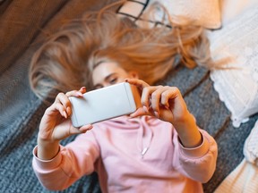 A young woman takes a selfie.