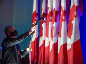 OSHAWA, ONTARIO: A person steams the Canadian flag at Oshawa's Tribute Communities Centre in preparation for Erin O'Toole's election night prior to results of the 2021 Federal election, Monday September 20, 2021.