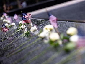 Flowers and American flags are seen at the reflecting pool of the 9/11 Memorial before memorial observances held at the site of the World Trade Center in New York City, New York, U.S., September 9, 2021.