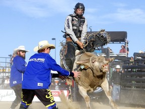 Jared Parsonage rides Spare Parts during the opening night of the Cody Snyder Charity Bullbustin’ event at the Grey Eagle Resort and Casino in Calgary on Tuesday, Sept. 7, 2021.