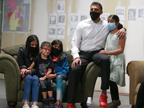 Calgary Skyview Liberal Party candidate George Chahal watches federal election results roll in with daughter Liv, right, and friends and family at his campaign headquarters on Monday, September 20, 2021.