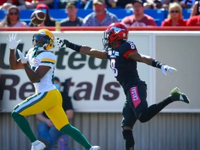 The Edmonton Elks’ Earnest Edwards makes a touchdown catch in front of the Calgary Stampeders’ DaShaun Amos at McMahon Stadium on Monday, Sept. 6, 2021.