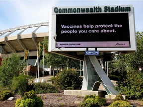 An advertisement promoting COVID-19 vaccinations is visible on a digital billboard outside Commonwealth Stadium. The Edmonton and Calgary Chambers of Commerce are calling on the province to implement a vaccine passport system after a survey found 70 per cent of businesses support the practice.
