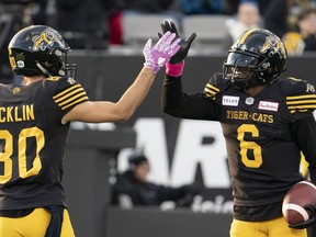 Hamilton Tiger Cats quarterback David Watford (6) celebrates his touchdown with teammate wide receiver Jaelon Acklin (80) during second half CFL football game action against the Ottawa Redblacks, in Hamilton, Ont., Saturday, Oct. 19, 2019. The Tiger-Cats re-signed American quarterback Watford on Wednesday.