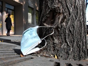 A discarded mask is seen caught on the stump of a tree along 8th Ave. S.W. Tuesday, September 7, 2021.