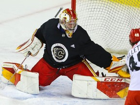 Goalie Dustin Wolf makes a save off Jakob Pelletier during the Calgary Flames prospects’ camp in on Thursday, Sept. 16, 2021.