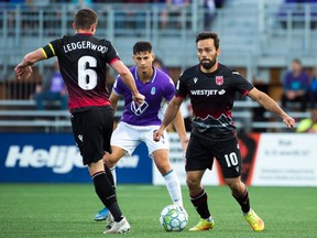 Cavalry FC (in black) battles Pacific FC in Canadian Premier League action at Starlight Stadium in Langford, B.C., on Thursday, Sept. 9, 2021.