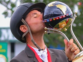 Steve Guerdat of Switzerland kissing the trophy after winning the CP International competition at the Spruce Meadows Masters in Calgary on Sunday, September 12, 2021. Al Charest / Postmedia