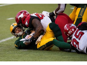 Edmonton Elks quarterback Trevor Harris (7) is sacked by Calgary Stampeders' Shawn Lemon (40) during first half CFL football action at Commonwealth Stadium in Edmonton, on Saturday, Sept. 11, 2021. Ian Kucerak/Postmedia Network