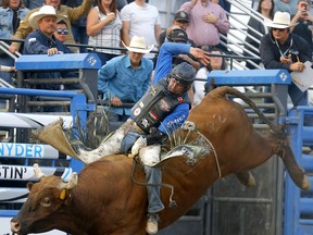 Bull-rider Dakota Buttar from Kindersley, Sask., rides Double Deuce during Night 2 of the Cody Snyder Charity Bullbustin' event at the Grey Eagle Resort and Casino in Calgary on Wednesday.