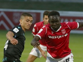 Pacific FC's Manuel Aparicio defends against Cavalry FC's Victor Loturi during CPL soccer action at ATCO Field in Calgary in this photo from Aug. 11.