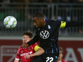 Cavalry FC's Nik Ledgerwood battle for the ball with Pacific FC's Jamar Dixon in the quarter-finals of the Canadian Championship at Spruce Meadows' ATCO Field on Wednesday night.