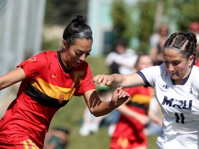 Dinos midfielder Montana Leonard is defended by the Mount Royal Cougars' Isabelle Chirico in this photo from earlier this season.
