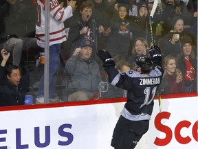 There were no fans to greet them, but Cael Zimmerman and the Hitmen still got to inhabit the ice at the Saddledome on Saturday.