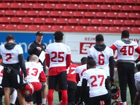 Stampeders players listen to head coach Dave Dickenson following practice at McMahon Stadium in Calgary on Thursday. The Stamps take on the Saskatchewan Roughriders on Saturday.