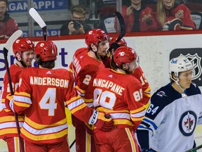 Calgary Flames celebrate their first goal against Winnipeg Jets during the first period of the preseason finale in Scotiabank Saddledome on Friday, October 8, 2021. Azin Ghaffari/Postmedia