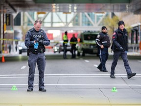Calgary police officers collect evidence at one of several scenes in downtown Calgary on Friday, October 15, 2021, connected to three random, violent attacks.
