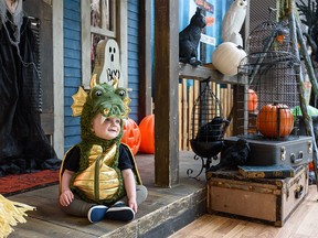 One-year-old Emmitt, dressed as a dragon, sits for a photo by his mom (not pictured) at one of the five Halloween-themed photo backdrops in Southcentre Mall on Wednesday, October 20, 2021.