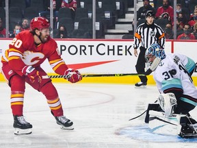 Blake Coleman #20 of the Calgary Flames takes a shot on Philipp Grubauer #31 of the Seattle Kraken during an NHL game at Scotiabank Saddledome on September 9, 2021 in Calgary, Alberta, Canada.