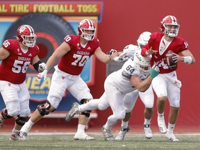 Jack Tuttle of the Indiana Hoosiers is nearly sacked by Jacob Slade of the Michigan State Spartans at Memorial Stadium in Bloomington, Ind., on Saturday, Oct. 16, 2021.