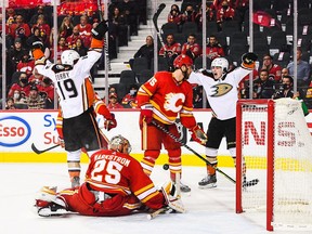 The Anaheim Ducks’ Jamie Drysdale scores in overtime against Calgary Flames goaltender Jacob Markstrom at Scotiabank Saddledome in Calgary on Monday, Oct. 18, 2021. i
