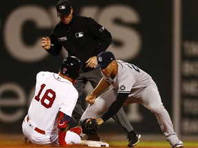 BOSTON, MASSACHUSETTS - SEPTEMBER 26: Kyle Schwarber #18 of the Boston Red Sox is tagged out at second base by Gleyber Torres #25 of the New York Yankees in the bottom of the seventh inning at Fenway Park on September 26, 2021 in Boston, Massachusetts.
