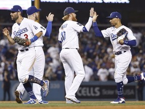 The Los Angeles Dodgers celebrate after defeating the Milwaukee Brewers 8-6 at Dodger Stadium in Los Angeles on Oct. 01, 2021.